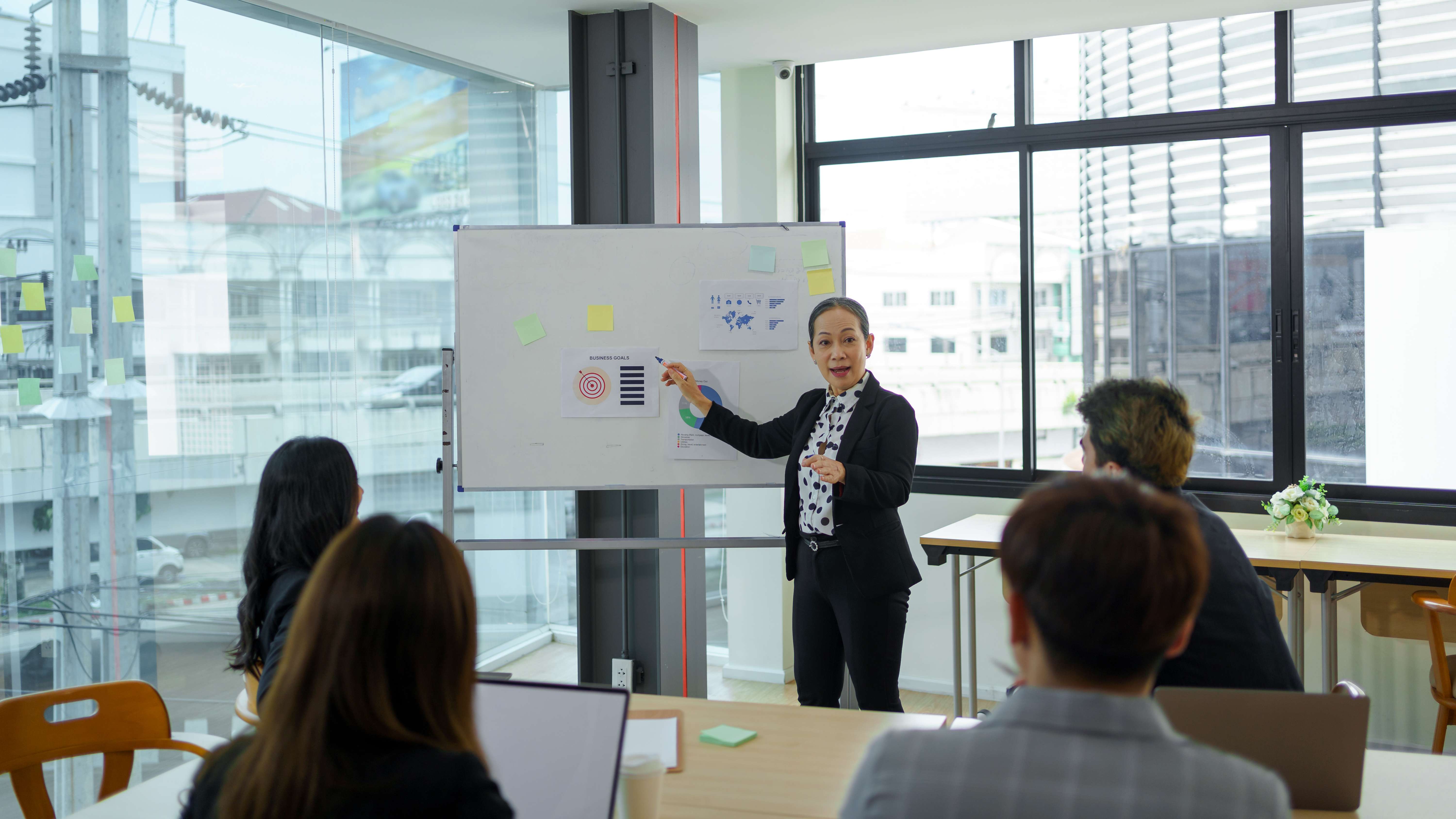 Expert consultant presenting strategic solutions to business professionals in modern conference room